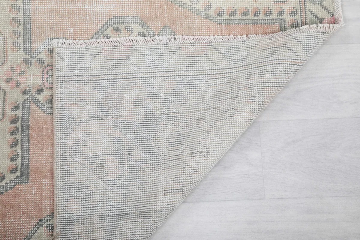 Another angle of the rug's back, showcasing the tightly woven cotton foundation.