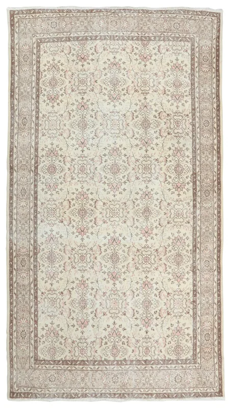 Full overhead view of the 6'6" x 10'0" ivory and rose Anatolian area rug with a brown border.