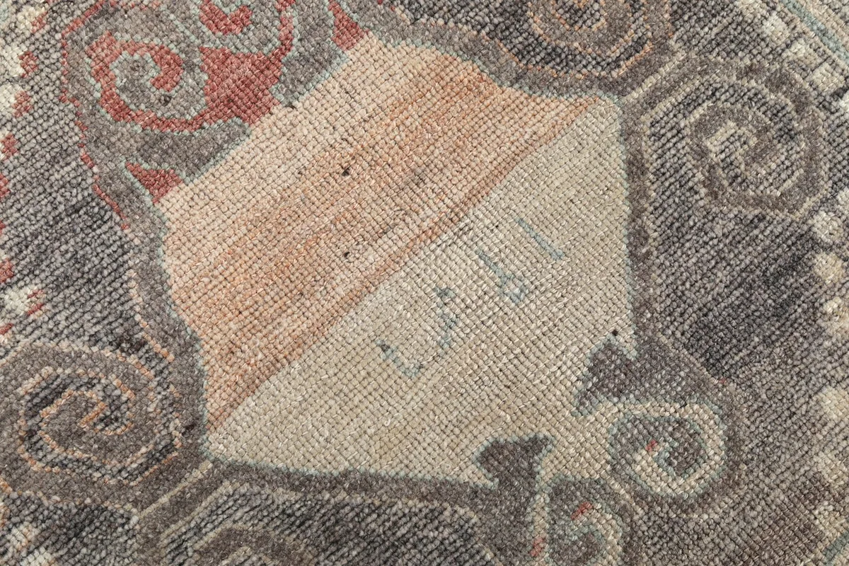 Close-up of the low pile, showing the texture and construction of the hand-knotted wool.