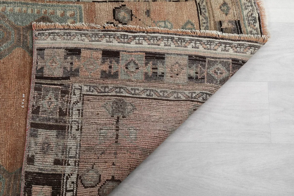 Backside of the runner rug, displaying the tight hand-knotted construction on the cotton foundation.
