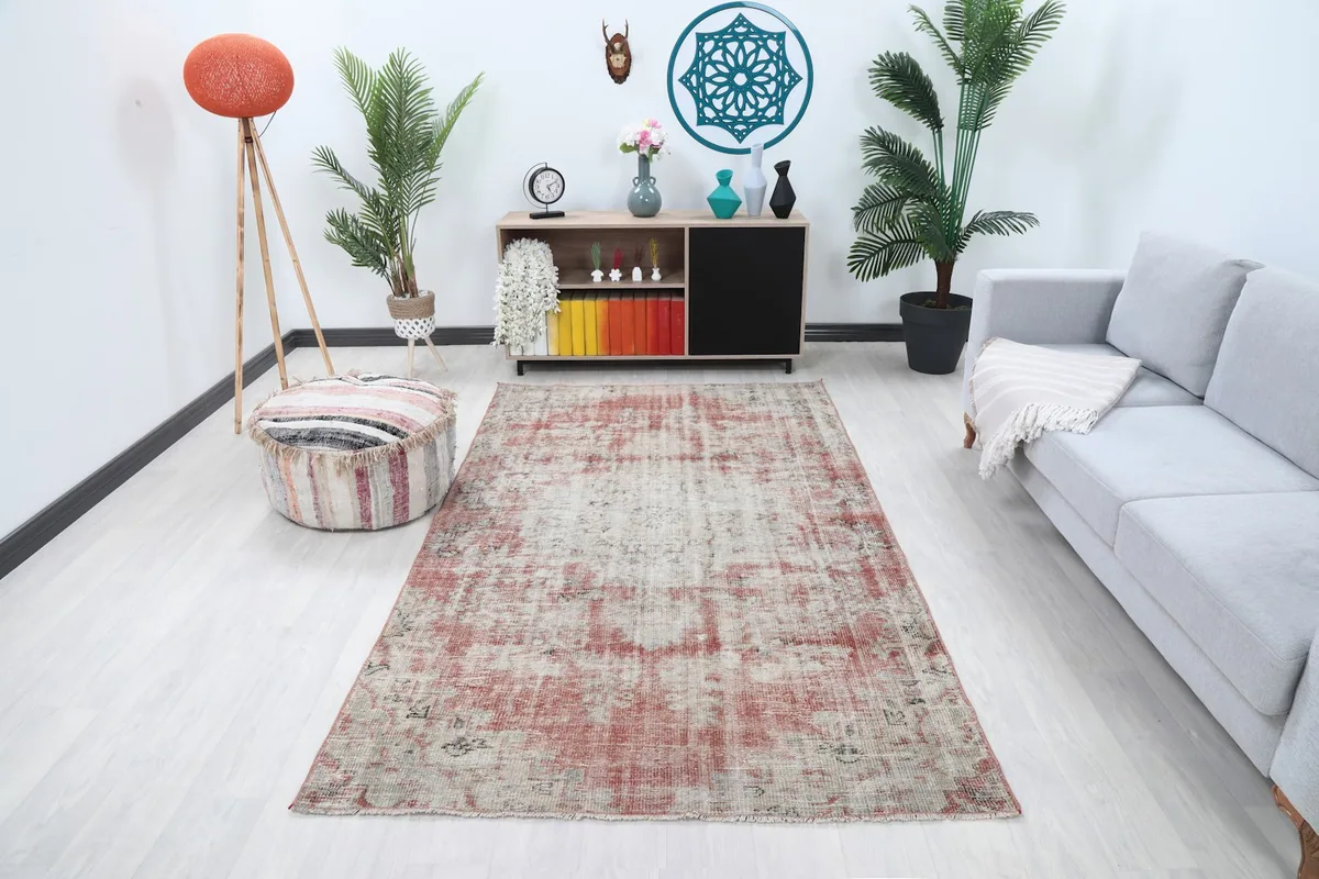 Vintage Anatolian rug in a living room setting with a light gray sofa and wooden furniture