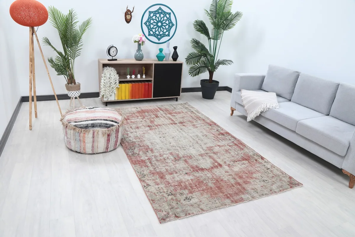 Angle view of the rose and beige rug laid out in a modern living space