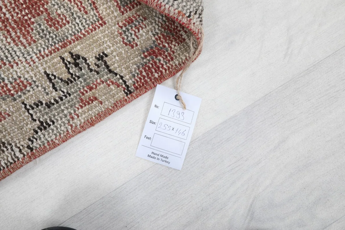 Corner of the rug with a product tag displaying size and inventory number