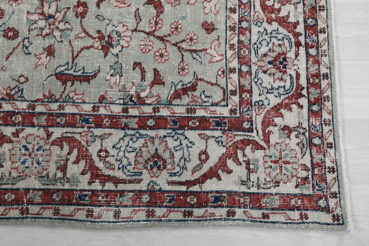 Detailed view of the rug's intricate red and cream border pattern
