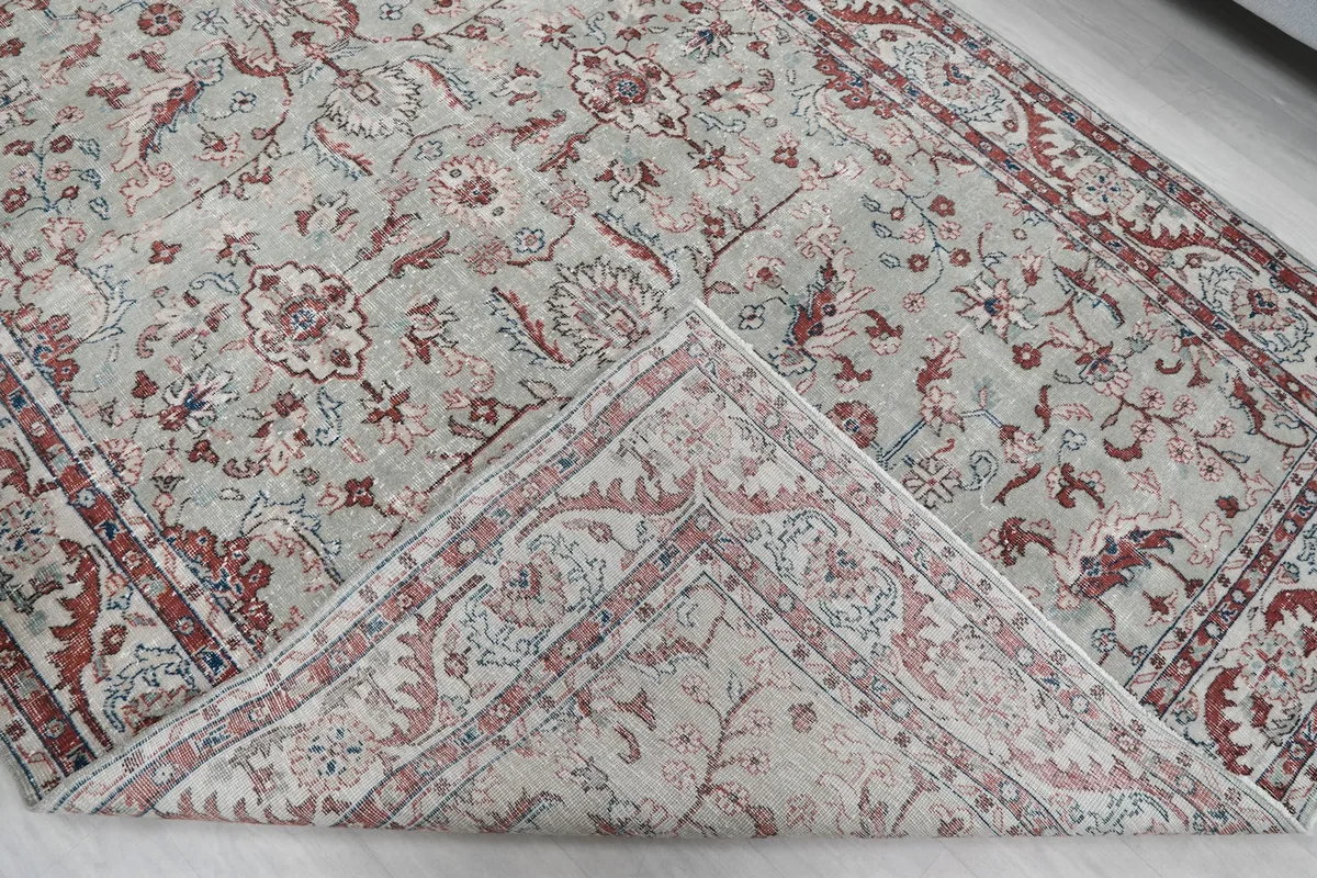 View of the rug's back and front, revealing its hand-knotted cotton foundation