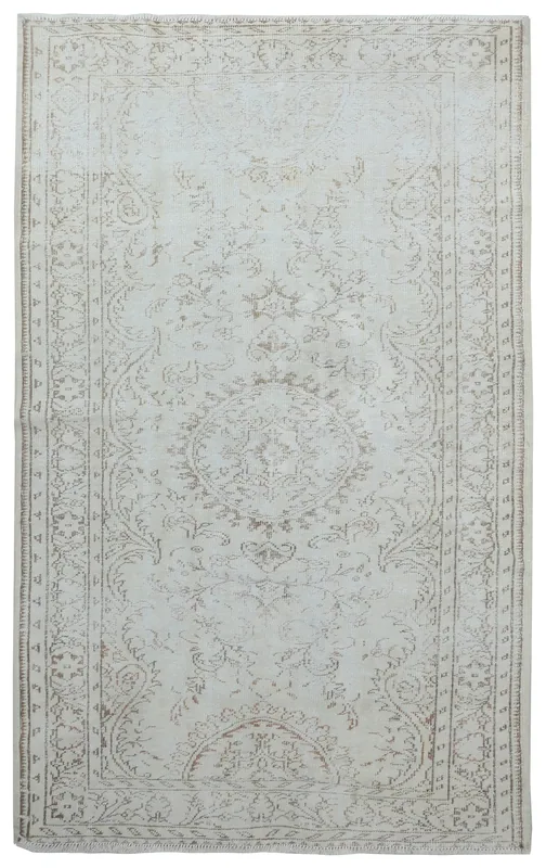 Full overhead view of the ivory and beige vintage Anatolian rug with tan medallion and patterns
