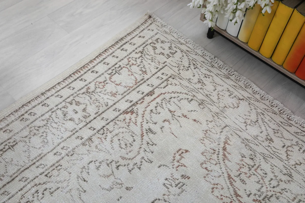 Detailed shot of the rug's border, revealing the patterned edges and the soft color blend