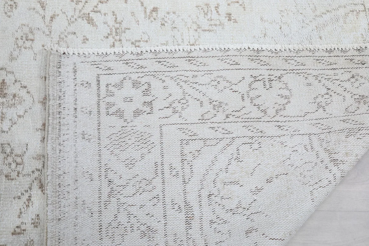 Close-up of the rug's edge, showing the hand-finished fringe and the tightly woven foundation
