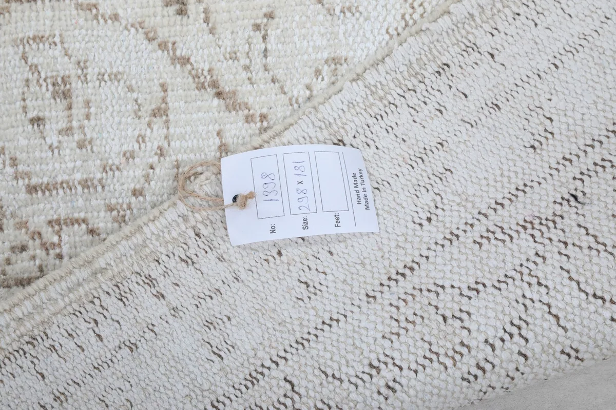 Detail of the rug's reverse side with a tag showing size and other product information
