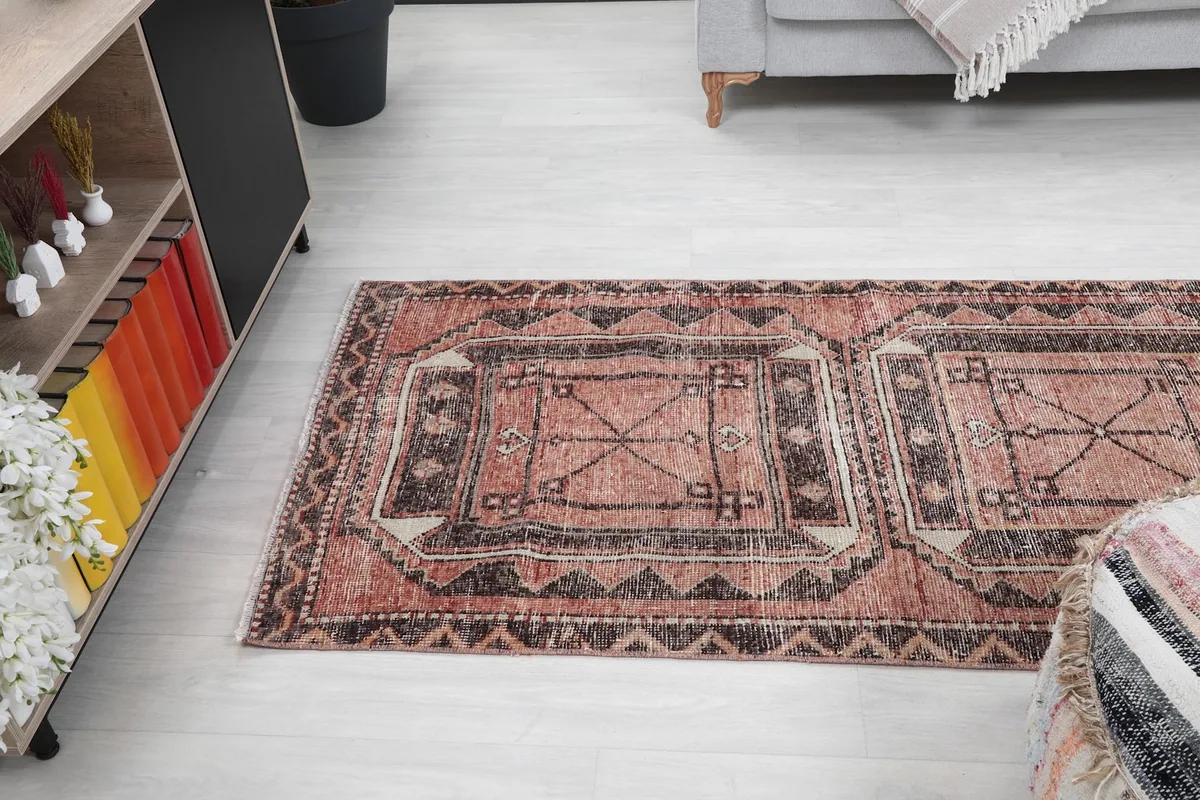 View of the runner rug from above, with furniture elements framing the composition.