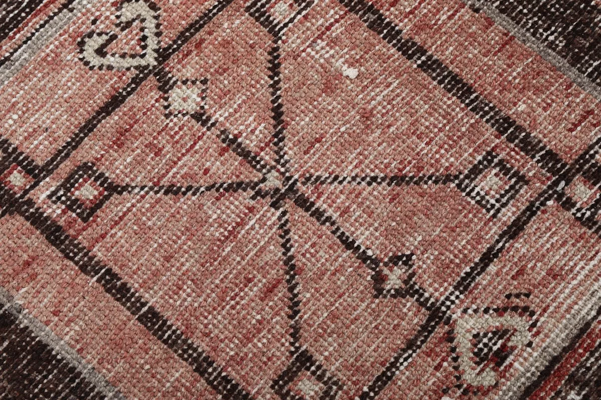 Extreme close-up of the rug's wool pile, showing the hand-knotted texture and subtle color blending.