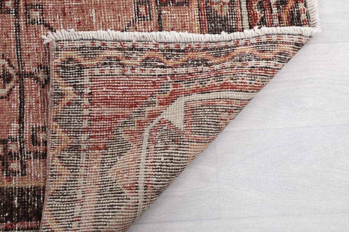 Another view of the rug's underside and fringe, highlighting the quality of the hand-knotted construction.