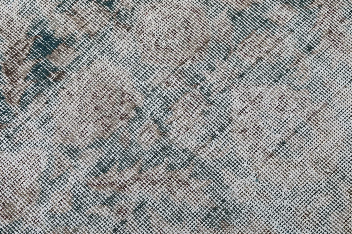 Close-up detail of the low wool pile, showing the hand-knotted texture and color blending