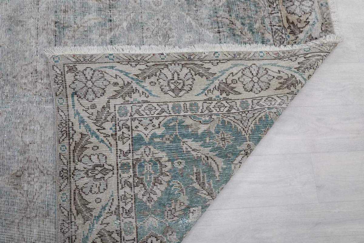Detail of the rug's back, showing the consistent knotting and structure of the vintage piece