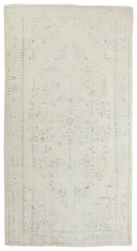 Full top view of the 6x10 ivory floral medallion vintage Anatolian rug on a white background.