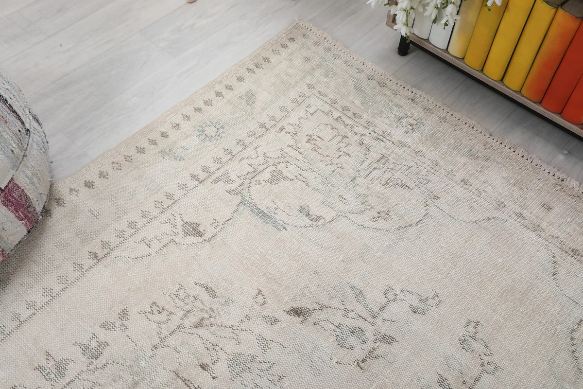 Corner view of the rug, illustrating the border and field patterns from an angle.