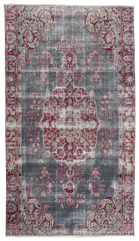 Full top view of the gray and red vintage Anatolian area rug with a central medallion.