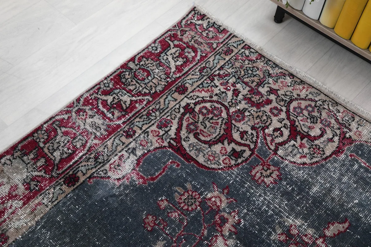 Corner view of the rug, showing the border and a glimpse of the main field.