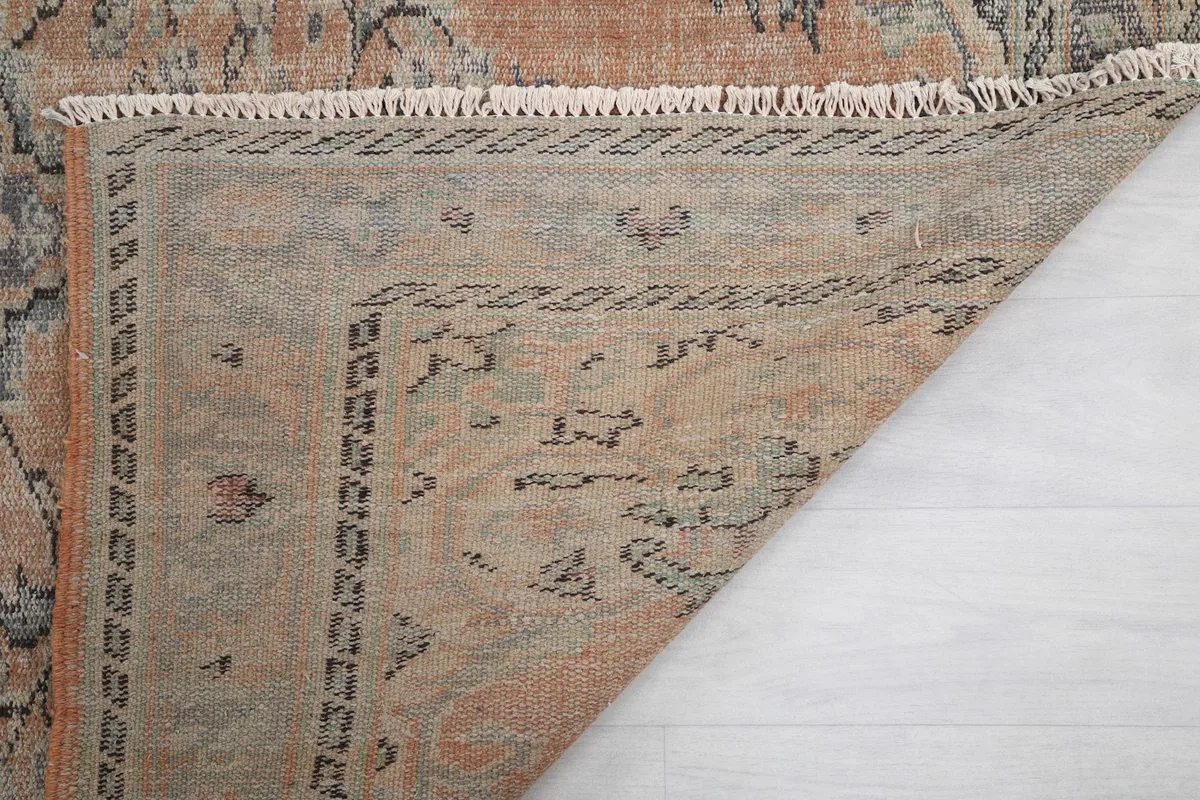 Corner of the rug folded back to show the reverse side and quality of craftsmanship