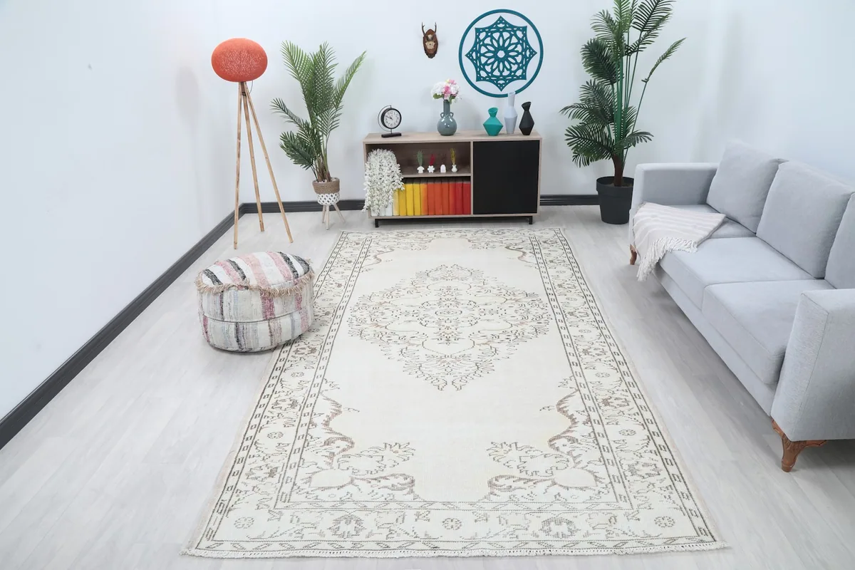 Ivory vintage rug displayed in a bright living room setting
