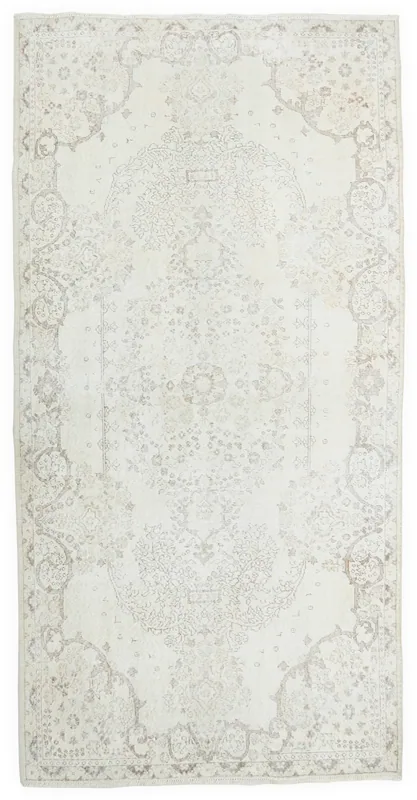 Full overhead view of the 5'9" x 9'5" ivory and beige Anatolian vintage area rug