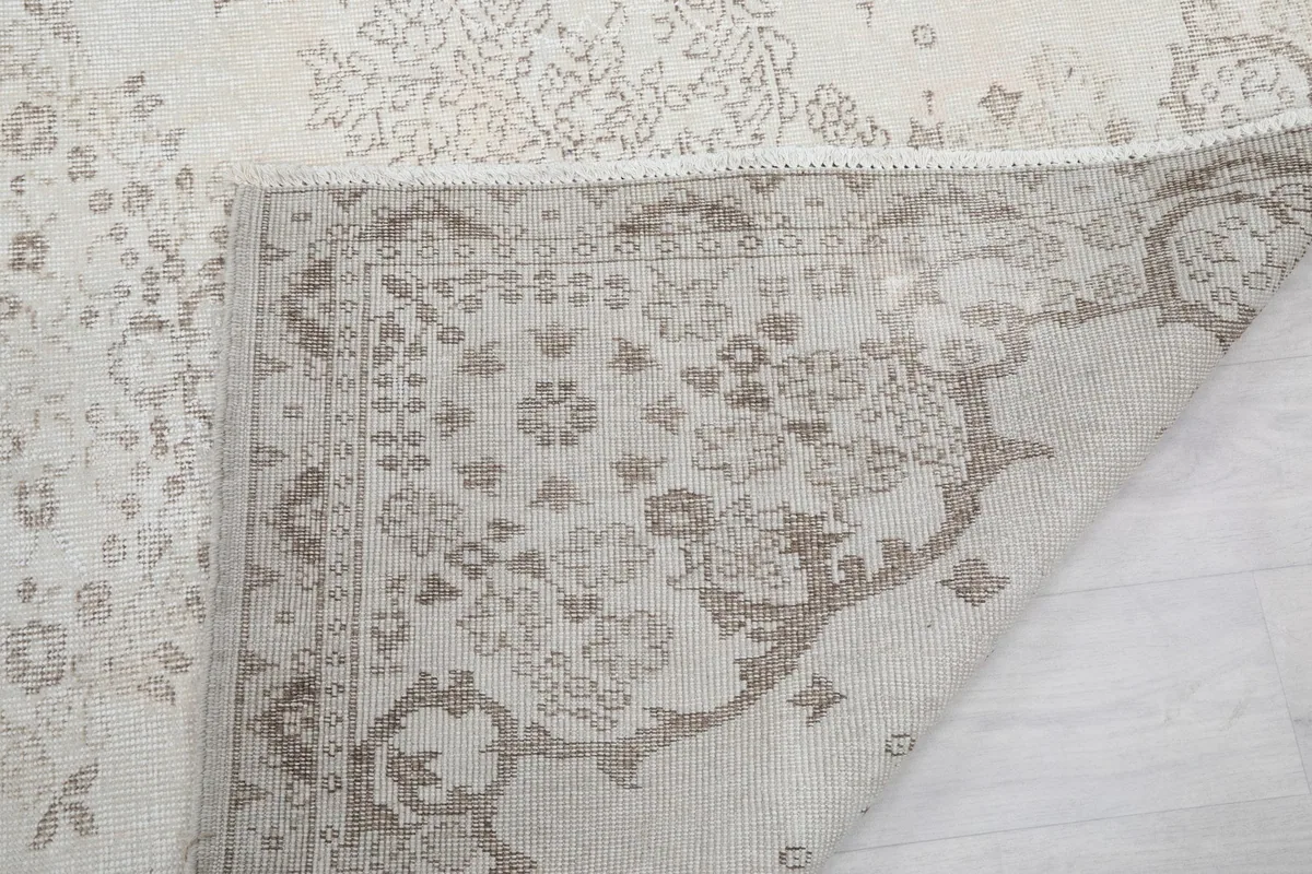 Folded corner of the rug showing the reverse side and the quality of the hand knotting