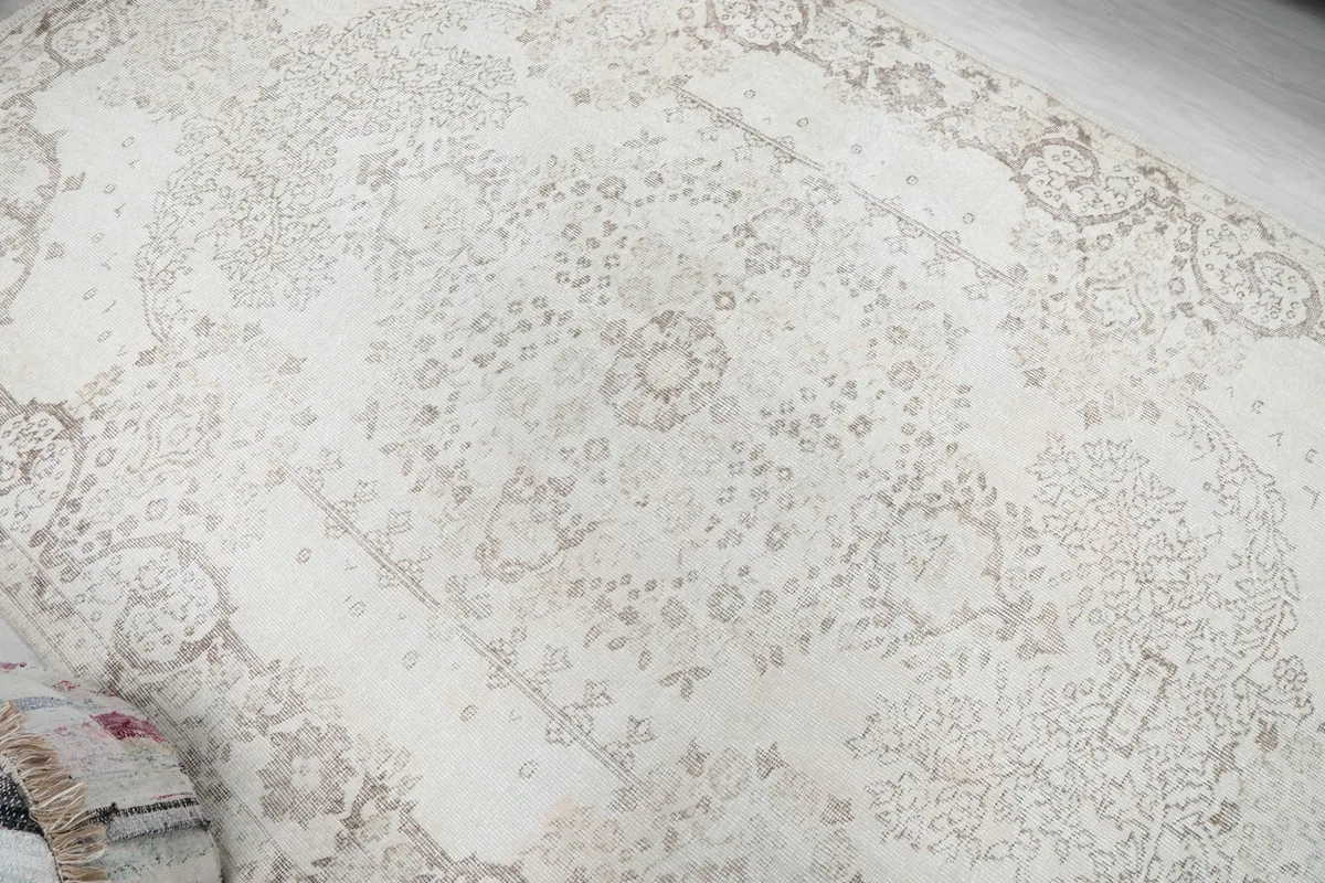 Top-down view of the rug's surface, revealing the overall distressed texture and design
