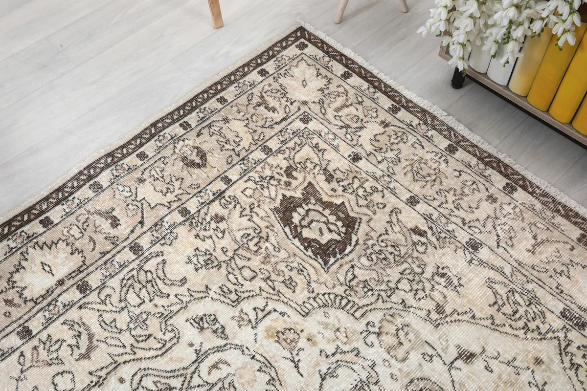 Corner detail showing the intricate brown patterns against the cream field