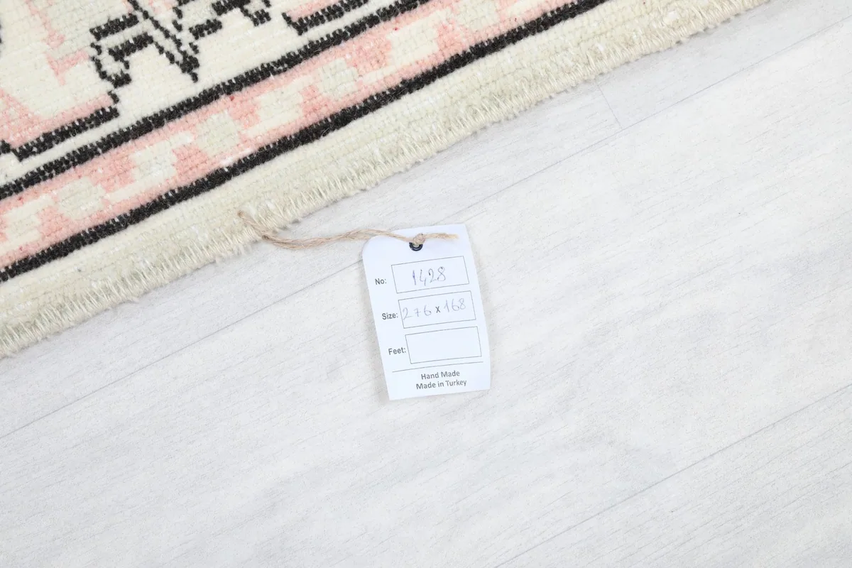 Close-up of the rug's corner with the product tag showing size and material details.