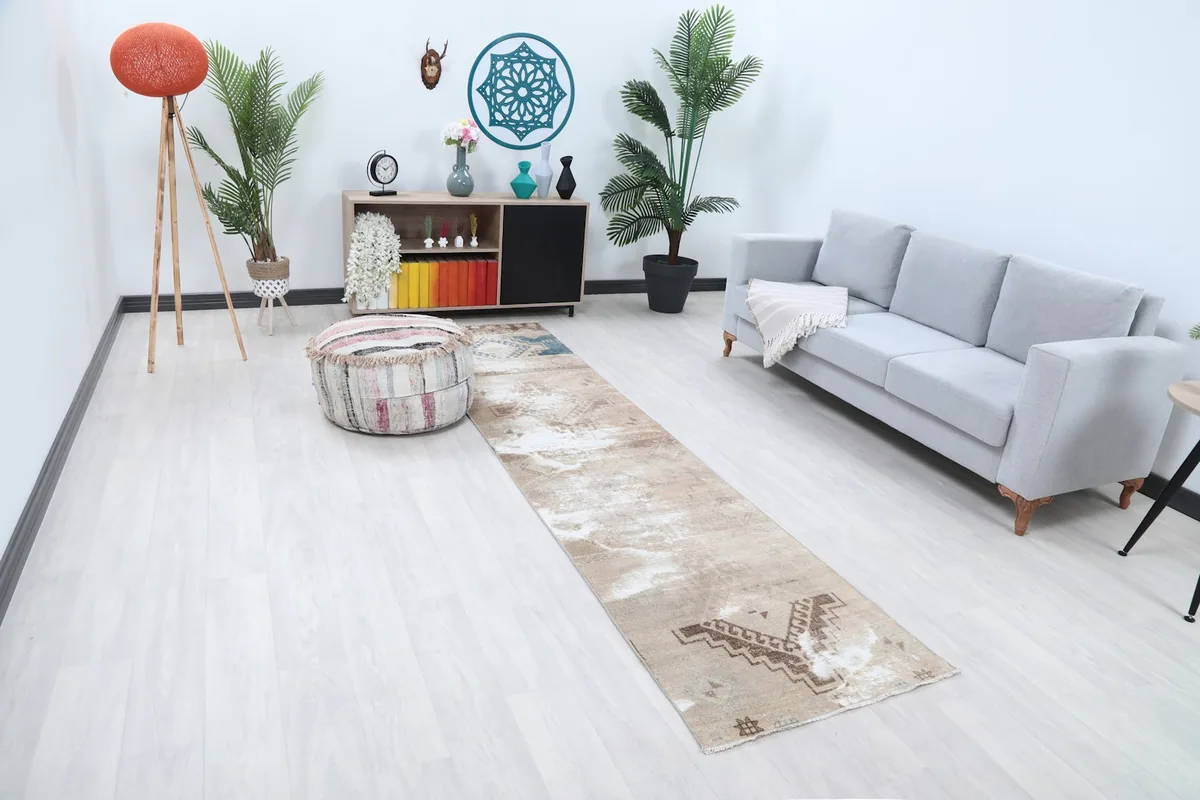 Angled view of the runner in a living space, highlighting the beige and brown tones.