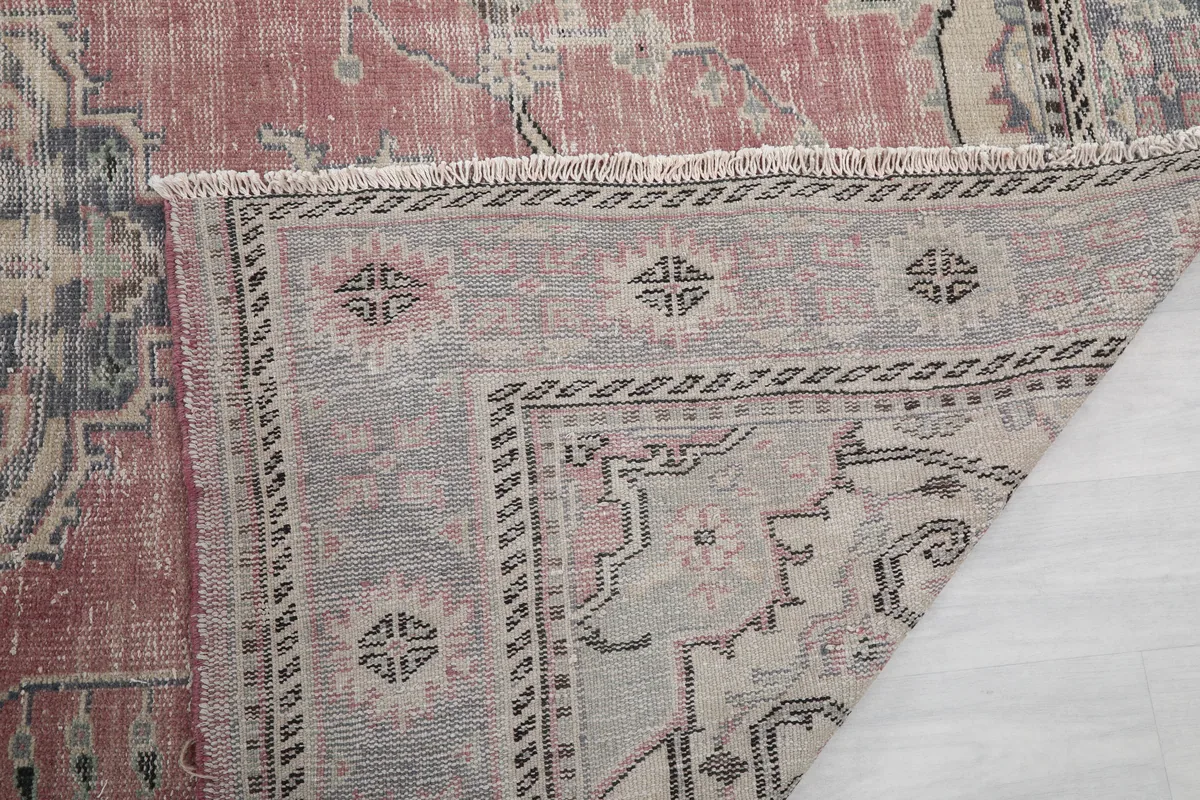 Close-up of the rug's back, showing the consistent knotting and fringe detail.