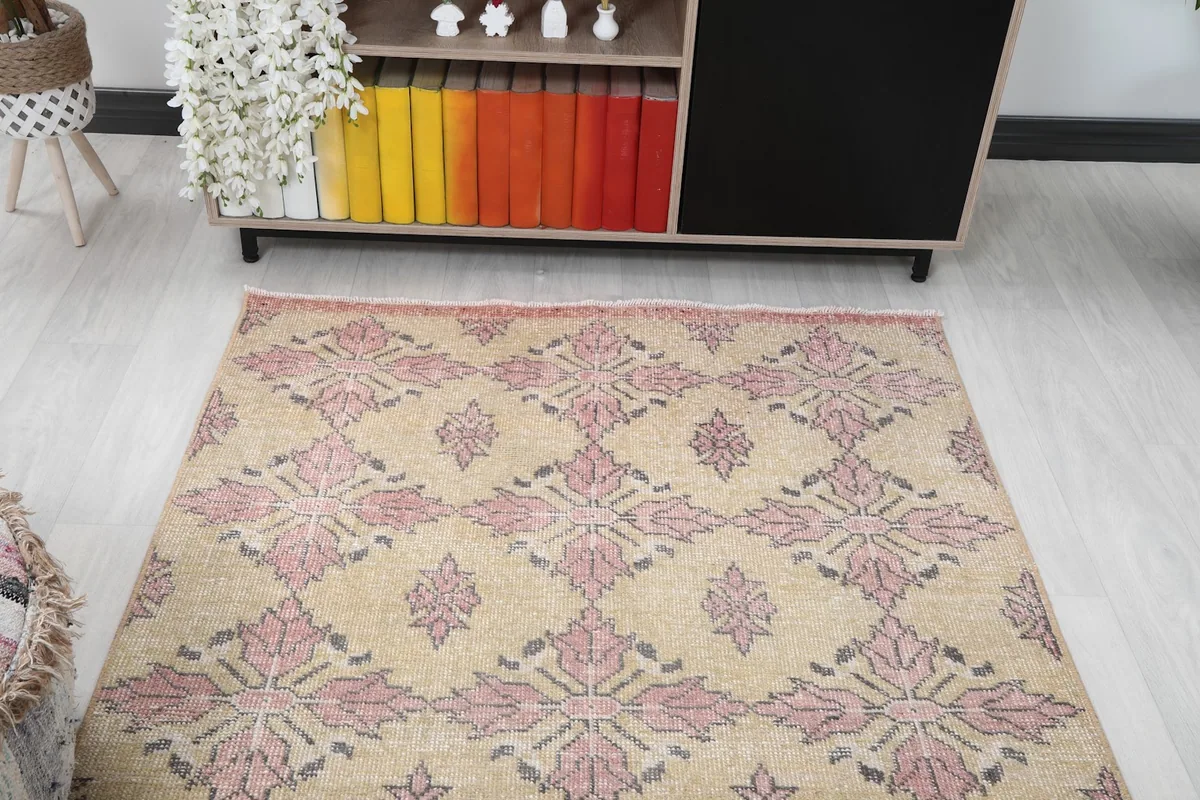 Angled view looking down the rug towards a colorful bookshelf
