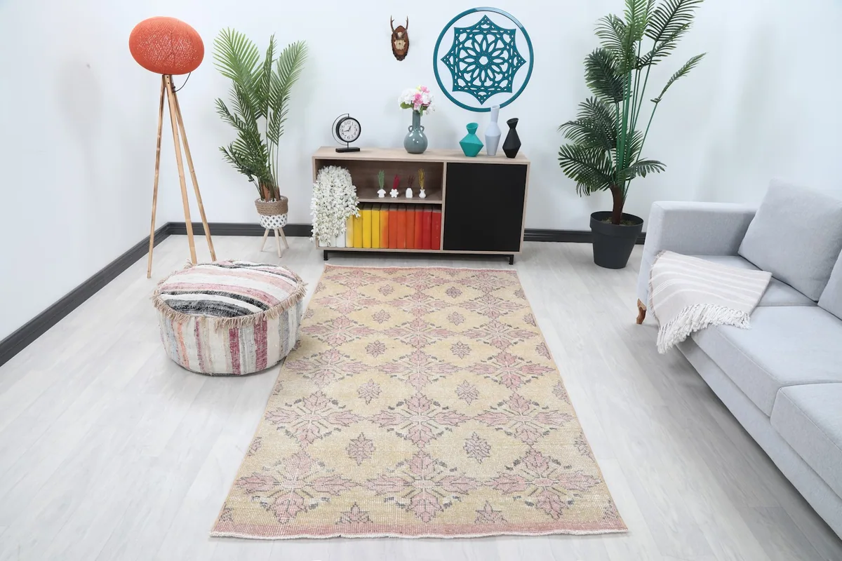 Vintage Anatolian rug in a living room setting with a light sofa and wooden furniture