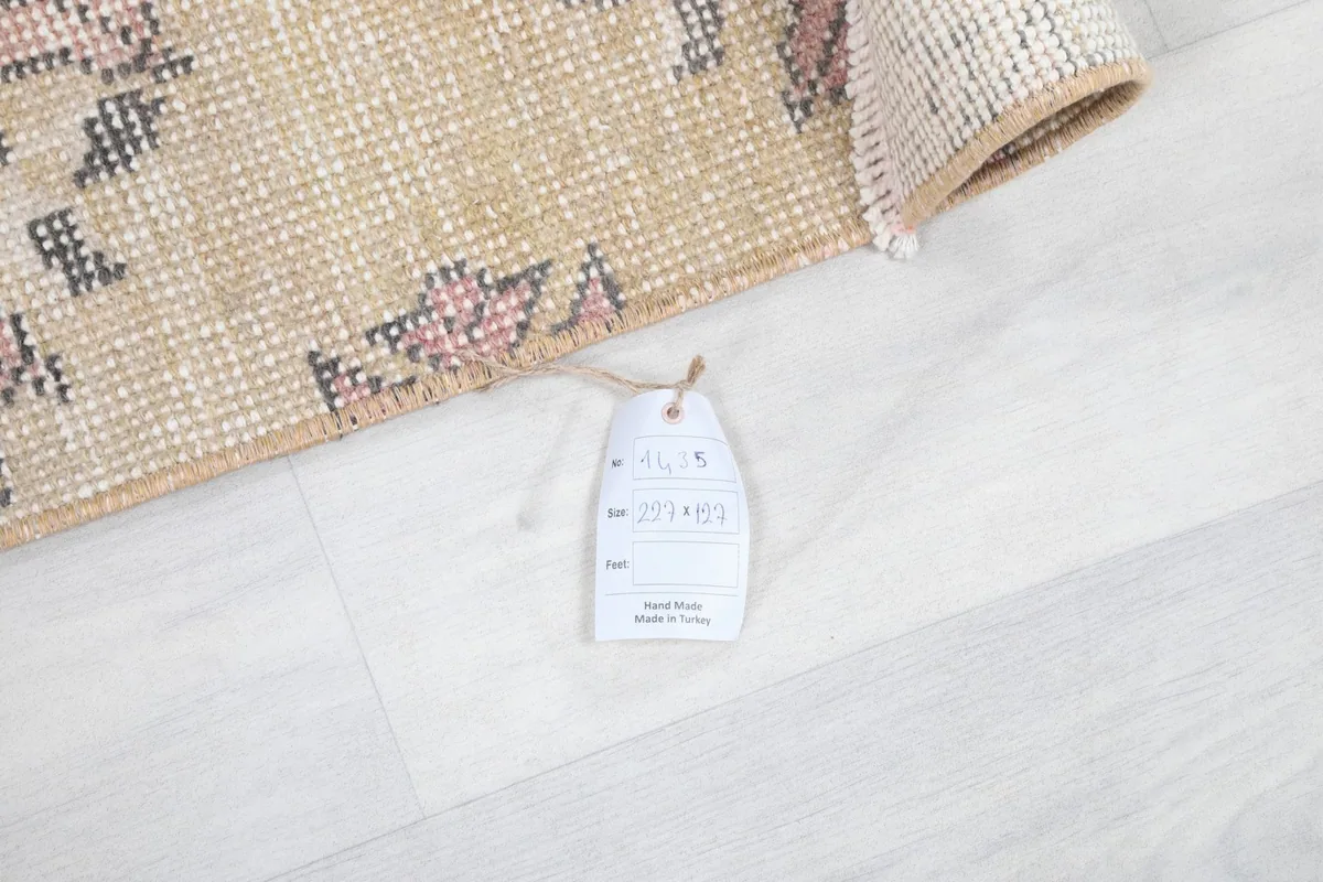 Rug with a product tag, showing its professional cleaning label and origin