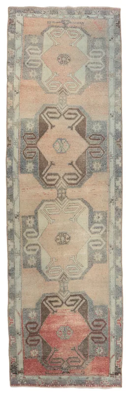 Full top view of the vintage rose and gray geometric Anatolian runner on a white background.