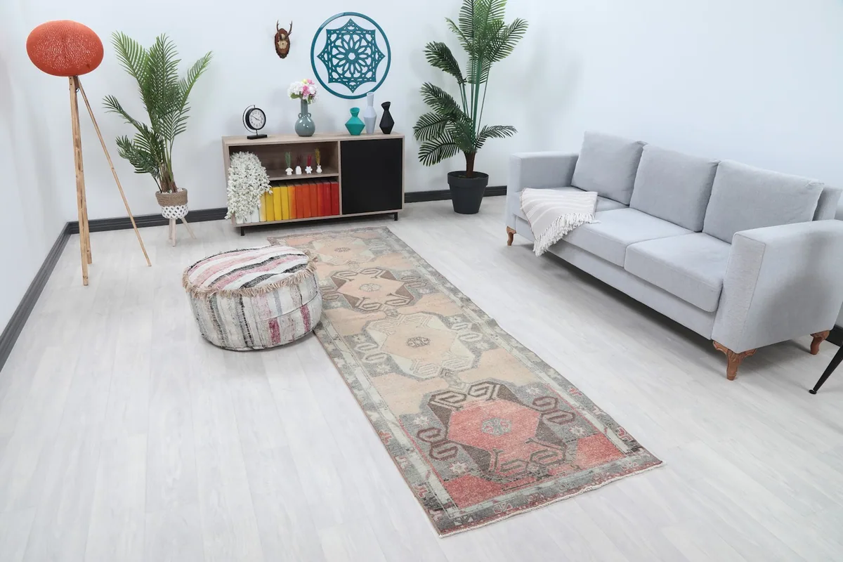 Overhead view of the rose and gray runner in a room, showing its length and placement near a sofa.