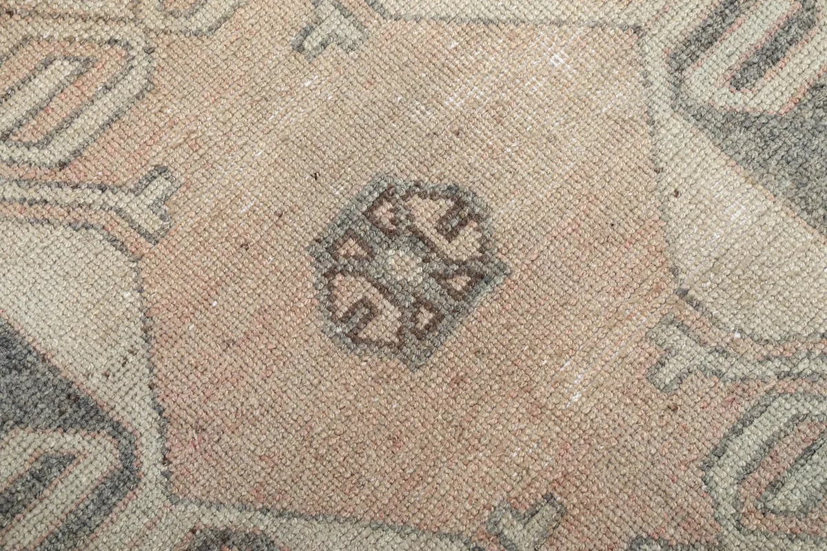 Close-up of the low wool pile, revealing the hand-knotted texture and color variations.