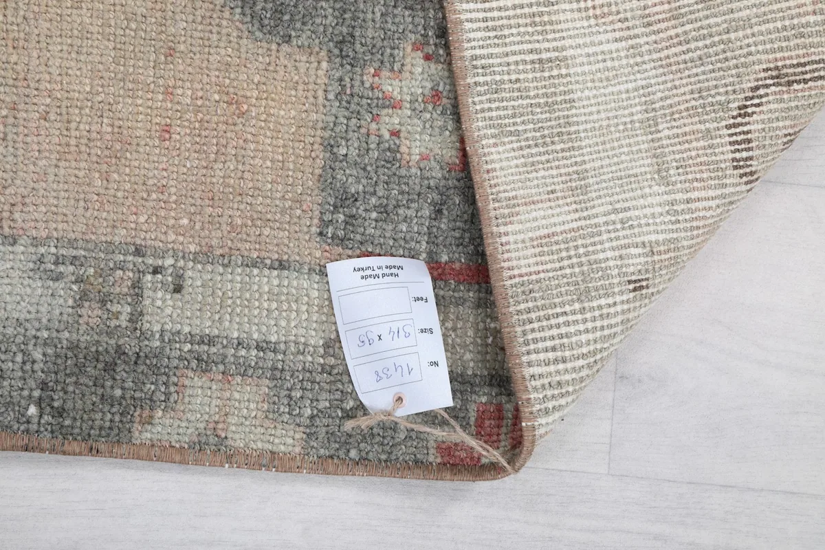 Close-up of the care tag attached to the back of the vintage Anatolian runner.