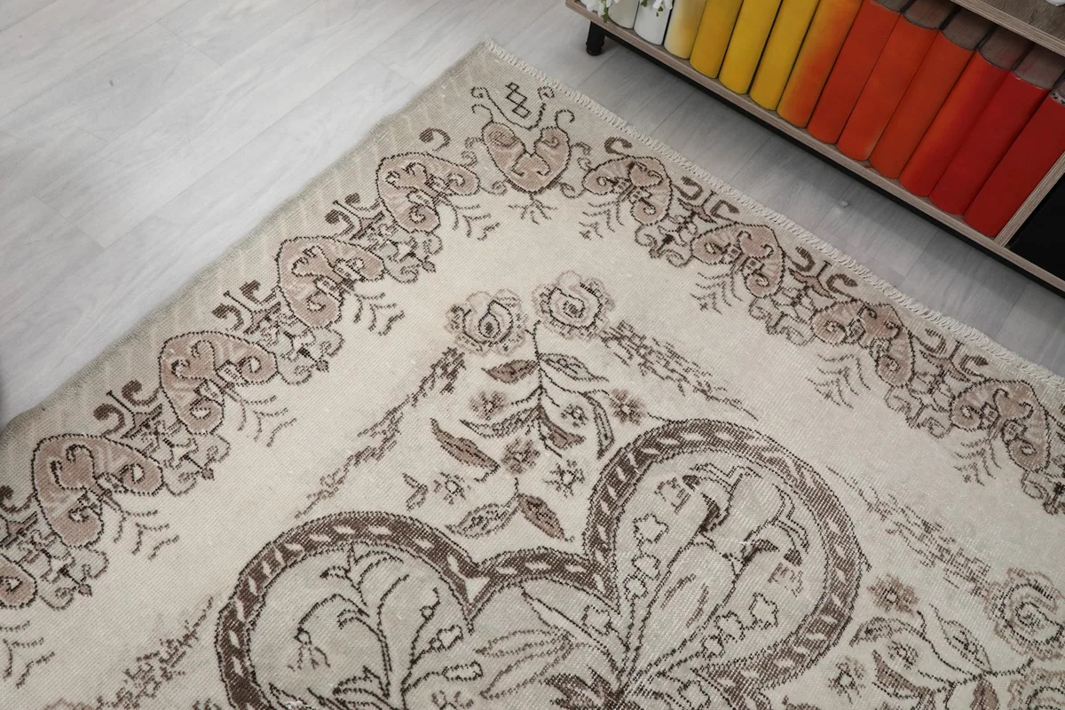 Corner detail of the rug, showing the intricate border and floral elements