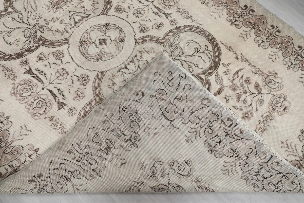 Folded corner of the rug revealing the wool pile and cotton foundation
