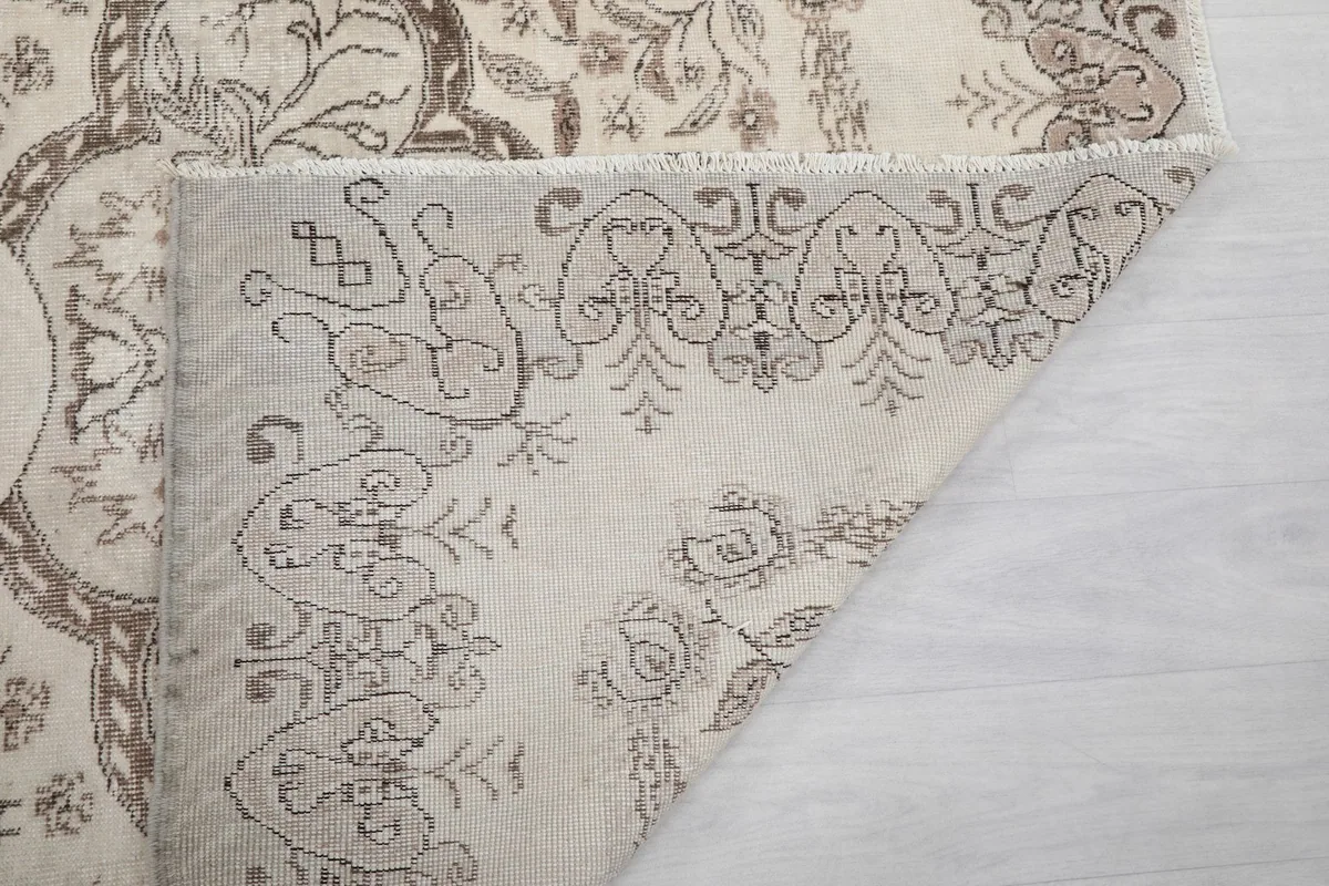 Another view of the folded rug corner, showing the hand-knotted construction