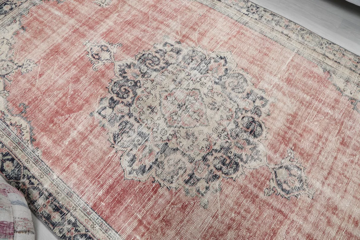 Overhead detail of the rug's central navy and ivory medallion design.