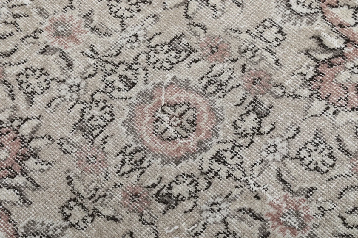 Close-up of the wool pile showing the subtle colors and hand-knotted texture