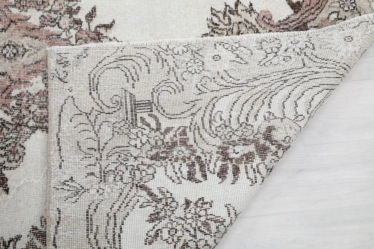 Detailed view of the rug's reverse side, showcasing the knotting and foundation