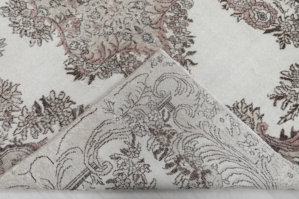 Folded corner of the rug revealing the reverse side of the hand-knotted cotton foundation