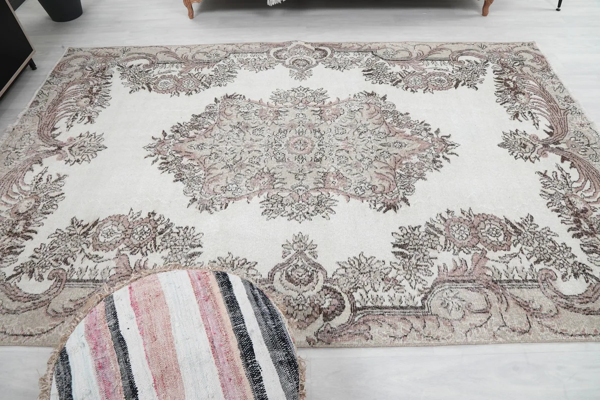 Overhead shot of the rug's central design and surrounding patterns in the room setting