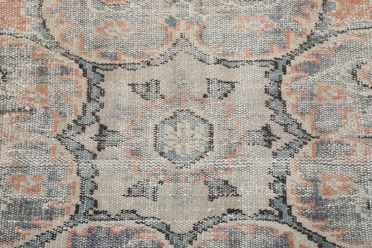 Macro detail of the hand-knotted wool pile and intricate geometric design