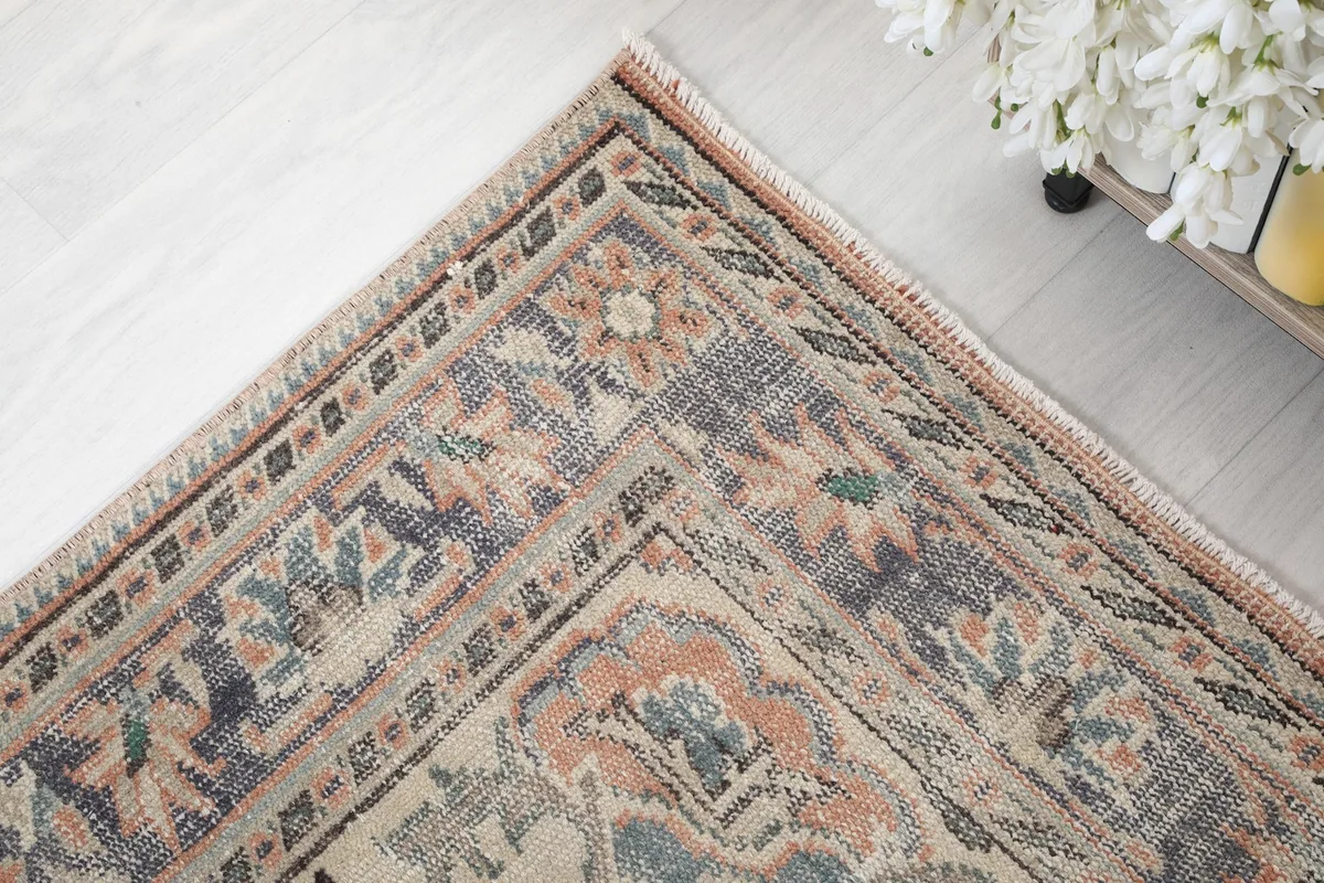 Detailed corner of the rug, highlighting the outer border patterns and colors