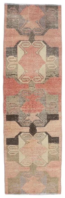 Full overhead view of the rose geometric vintage Anatolian runner on a white background.