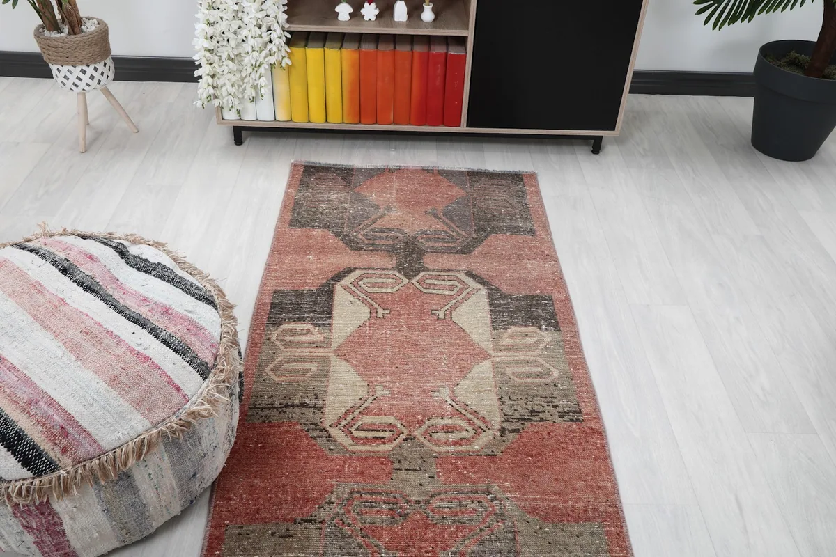 Top-down view of the runner in a room, focusing on the central design near a decorative ottoman.